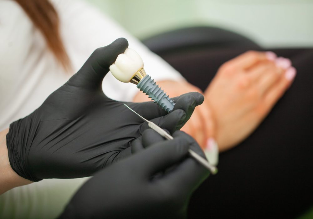 Dentist explaining teeth model to female patient. Technical shots on a dental prothetic laboratory.